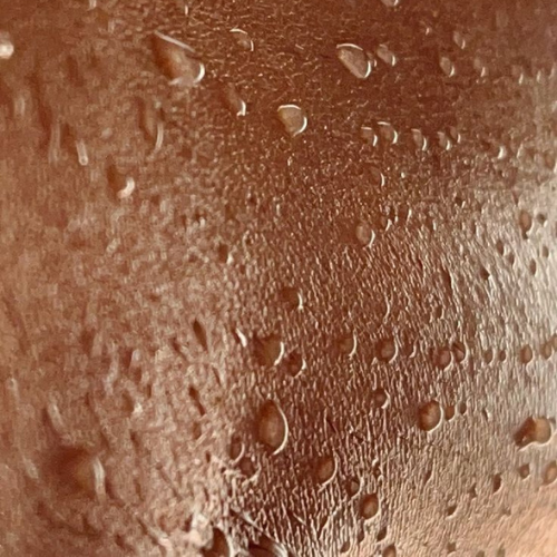 Skin and water droplets close up hydrated skin